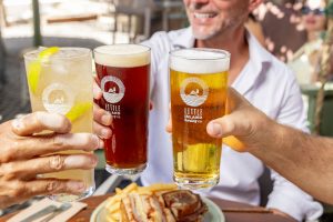 Colleagues toasting with drinks at The Island at Elizabeth Quay, a leading corporate function venue in Perth