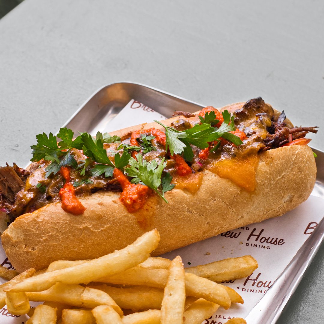 Smoked beef rib roll with melted cheese, chili sauce and parsley, served with crispy chips at the best lunch spot in Perth CBD